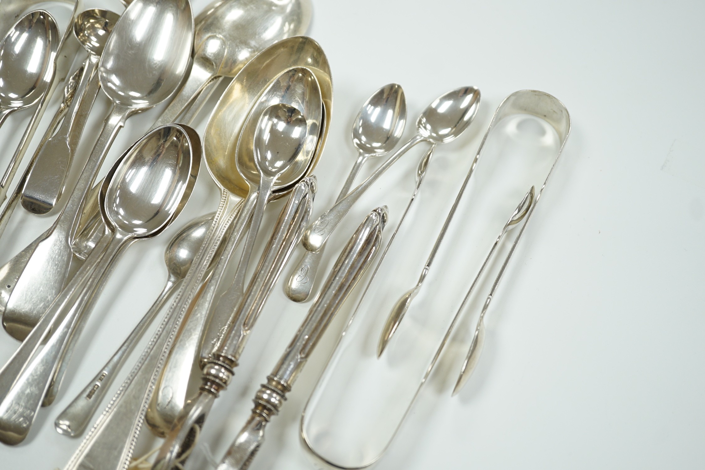 A quantity of assorted mainly 19th century silver flatware, various patterns, dates and makers, including a cased set of six 1937 Coronation silver teaspoons, four pairs of Georgian sugar tongs and a pair of Edwardian si